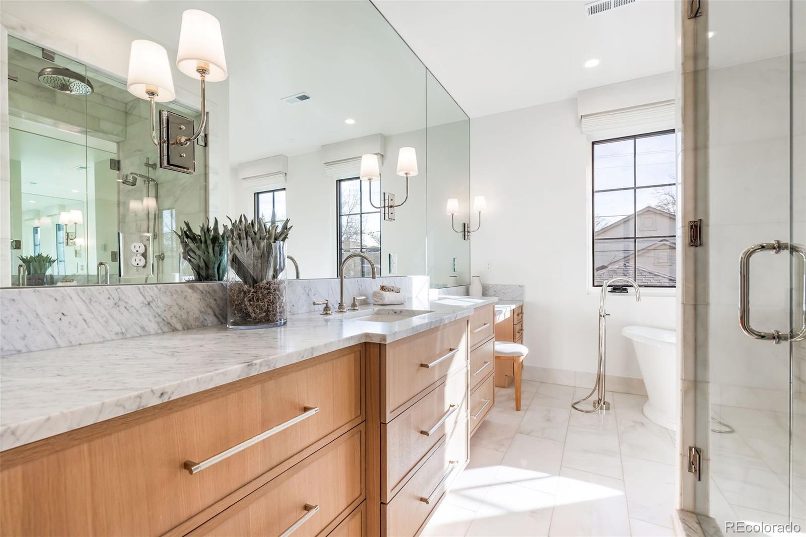 1026 South High Street Denver, CO 80209 - Photo 27 of 50 a bathroom with a double vanity sink mirror and shower