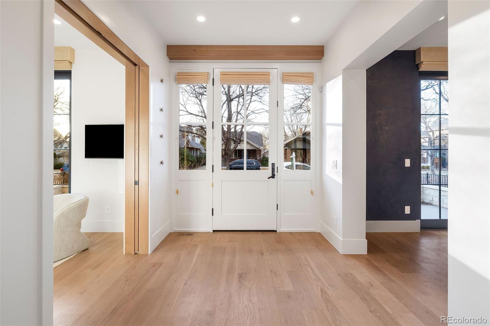 1026 South High Street Denver, CO 80209 - Photo 3 of 50 a view of a big room with wooden floor and windows