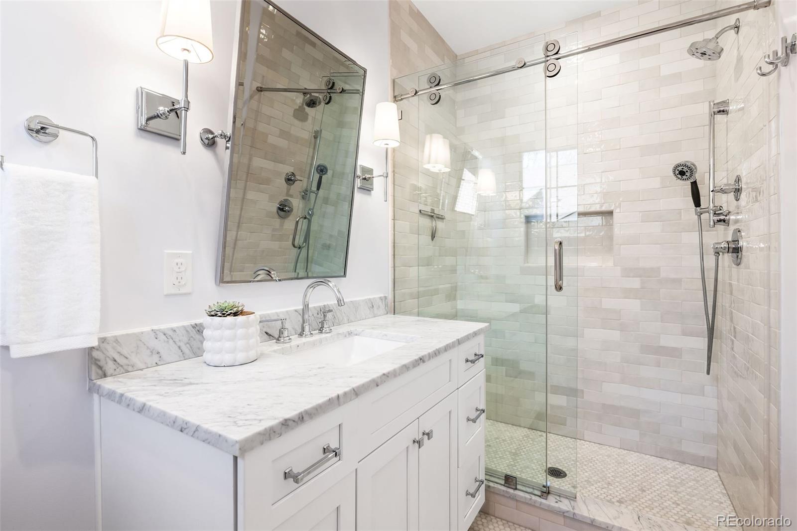 1026 South High Street Denver, CO 80209 - Photo 33 of 50 a bathroom with a sink shower and a mirror