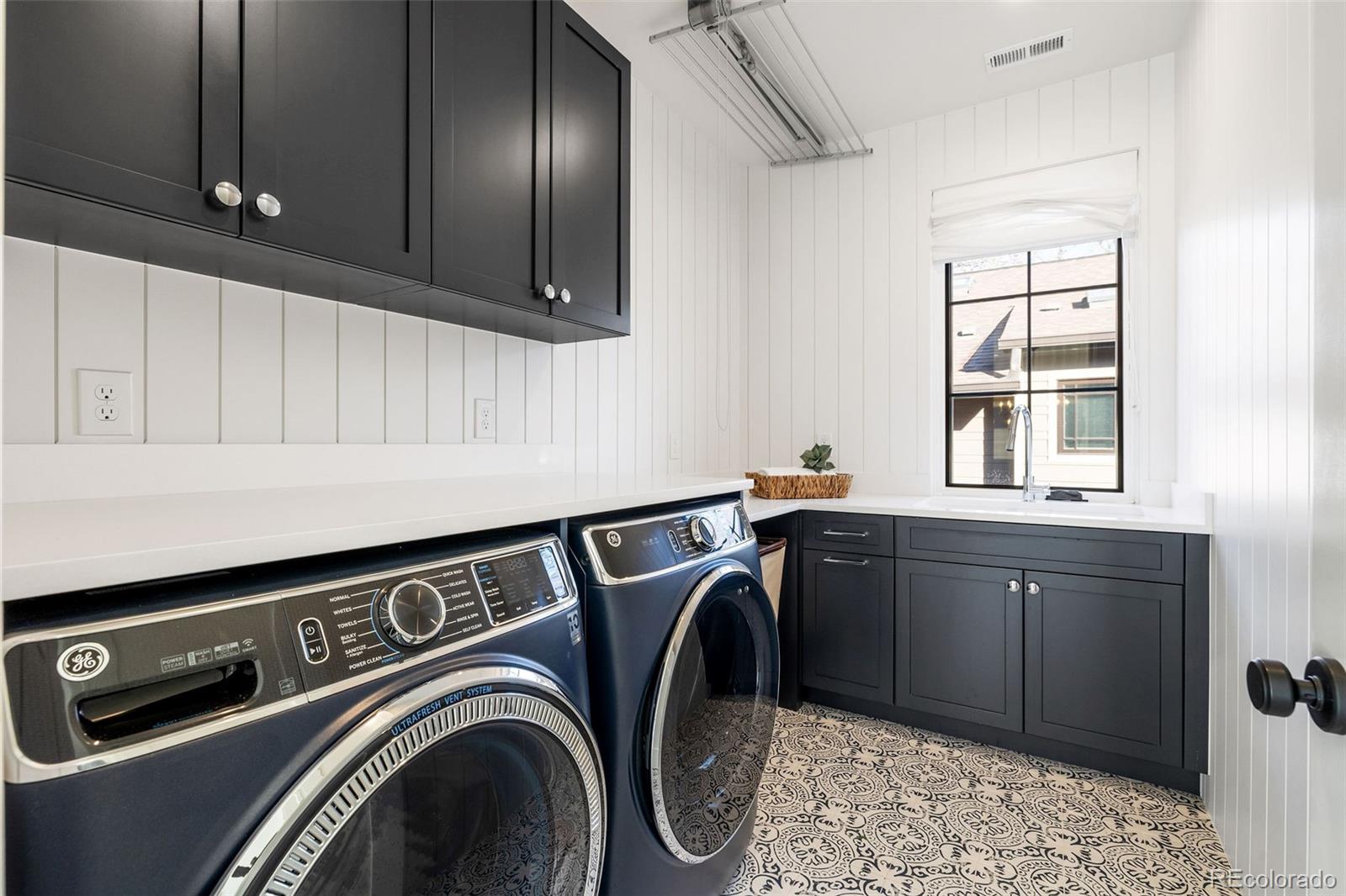 1026 South High Street Denver, CO 80209 - Photo 37 of 50 a utility room with sink dryer and washer