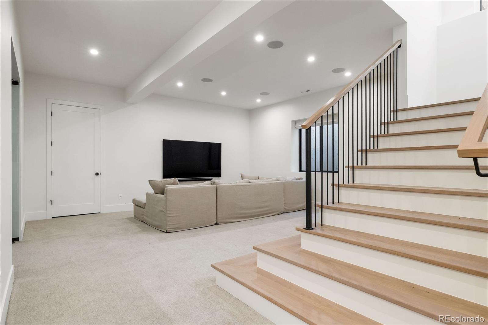1026 South High Street Denver, CO 80209 - Photo 38 of 50 a living room with furniture and a flat screen tv