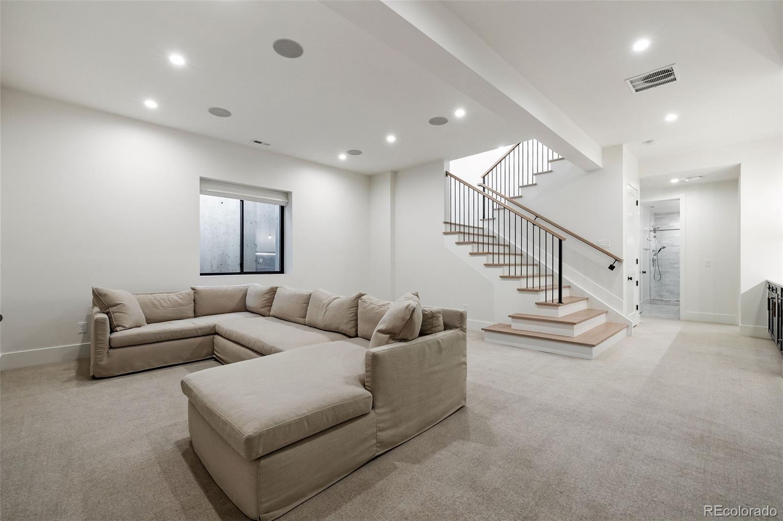 1026 South High Street Denver, CO 80209 - Photo 39 of 50 a living room with furniture and stairs