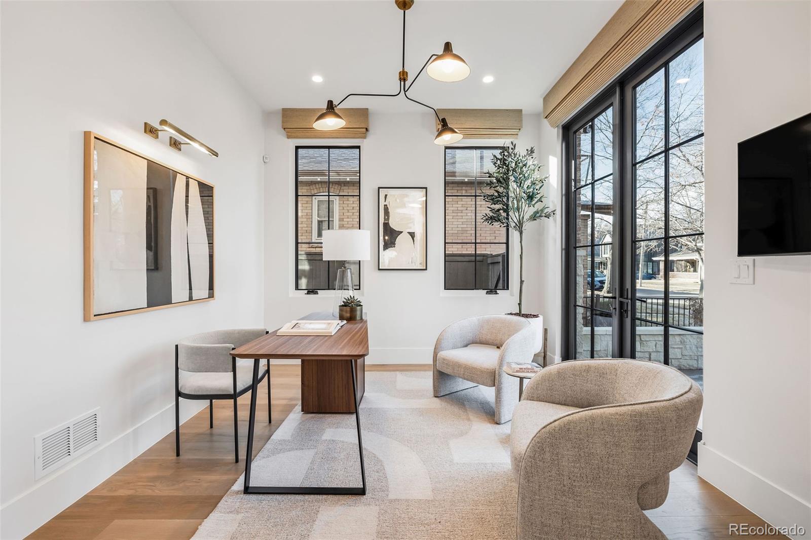 1026 South High Street Denver, CO 80209 - Photo 4 of 50 a living room with furniture a flat screen tv and floor to ceiling window