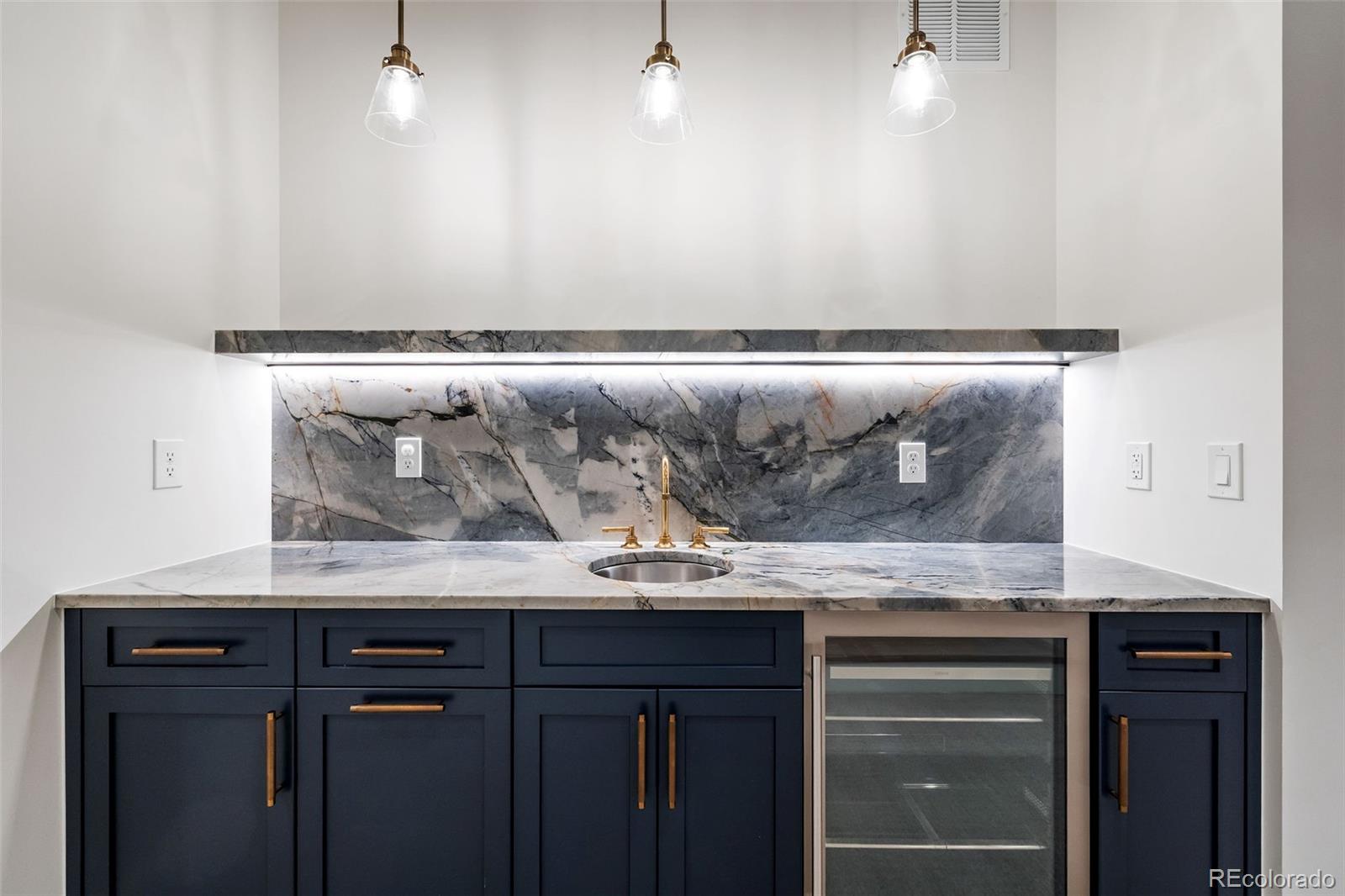 1026 South High Street Denver, CO 80209 - Photo 41 of 50 a sink with granite countertop cabinets