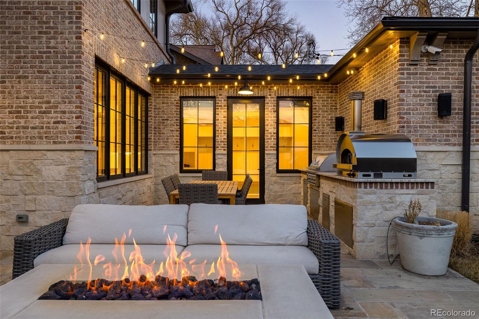 1026 South High Street Denver, CO 80209 - Photo 48 of 50 a living room with furniture a flat screen tv and a fireplace