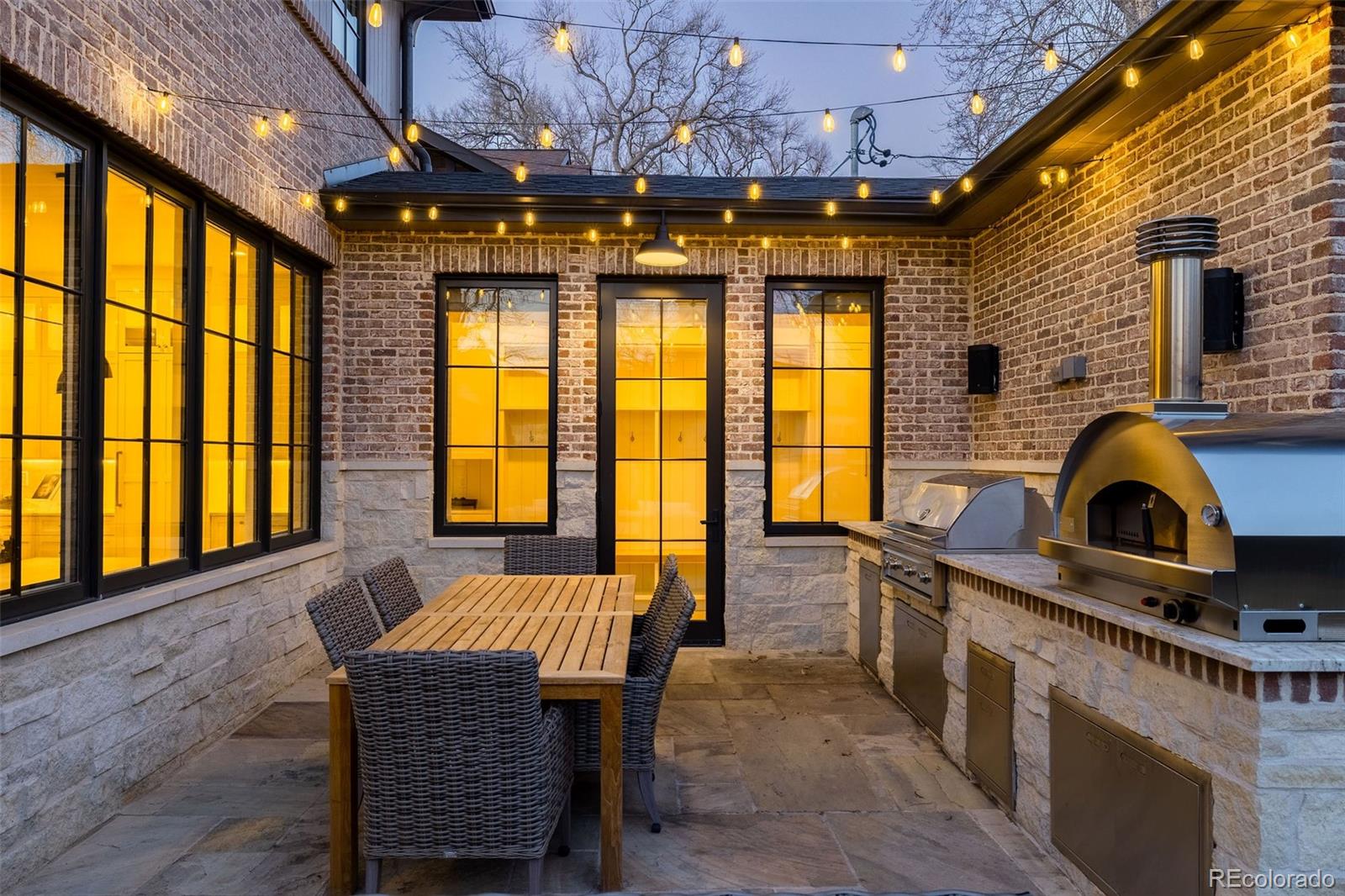 1026 South High Street Denver, CO 80209 - Photo 49 of 50 a view of a dining room with furniture a chandelier and wooden floor