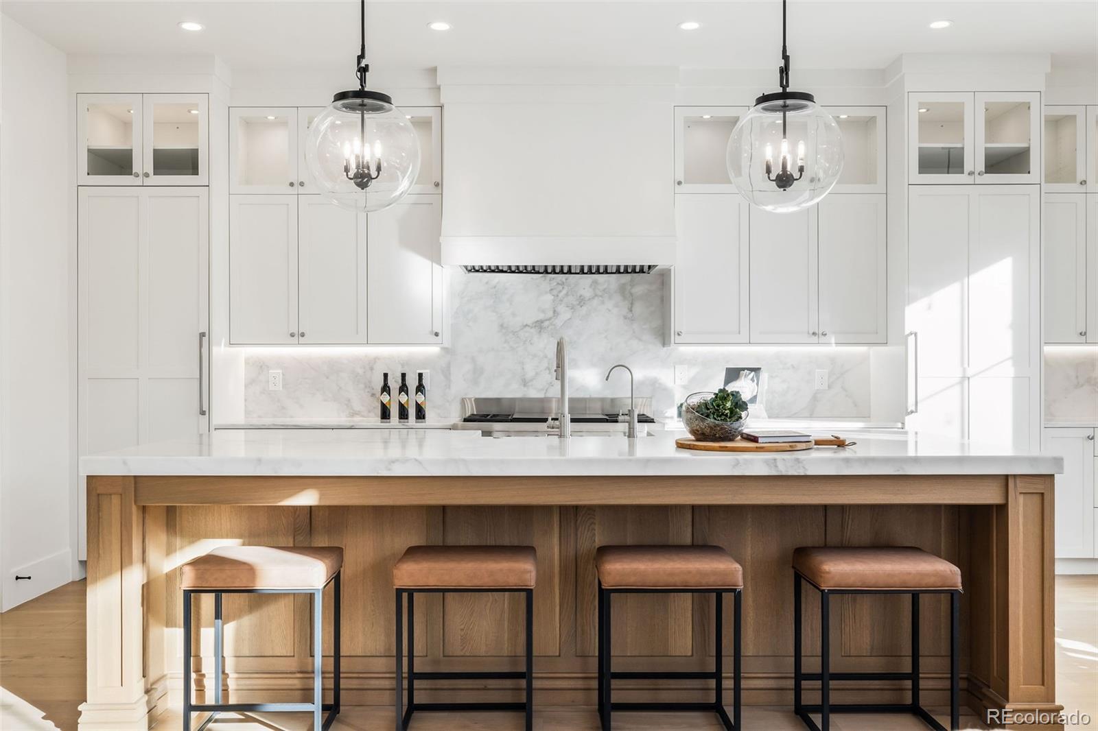 1026 South High Street Denver, CO 80209 - Photo 10 of 50 a kitchen with granite countertop a sink a center island and cabinets