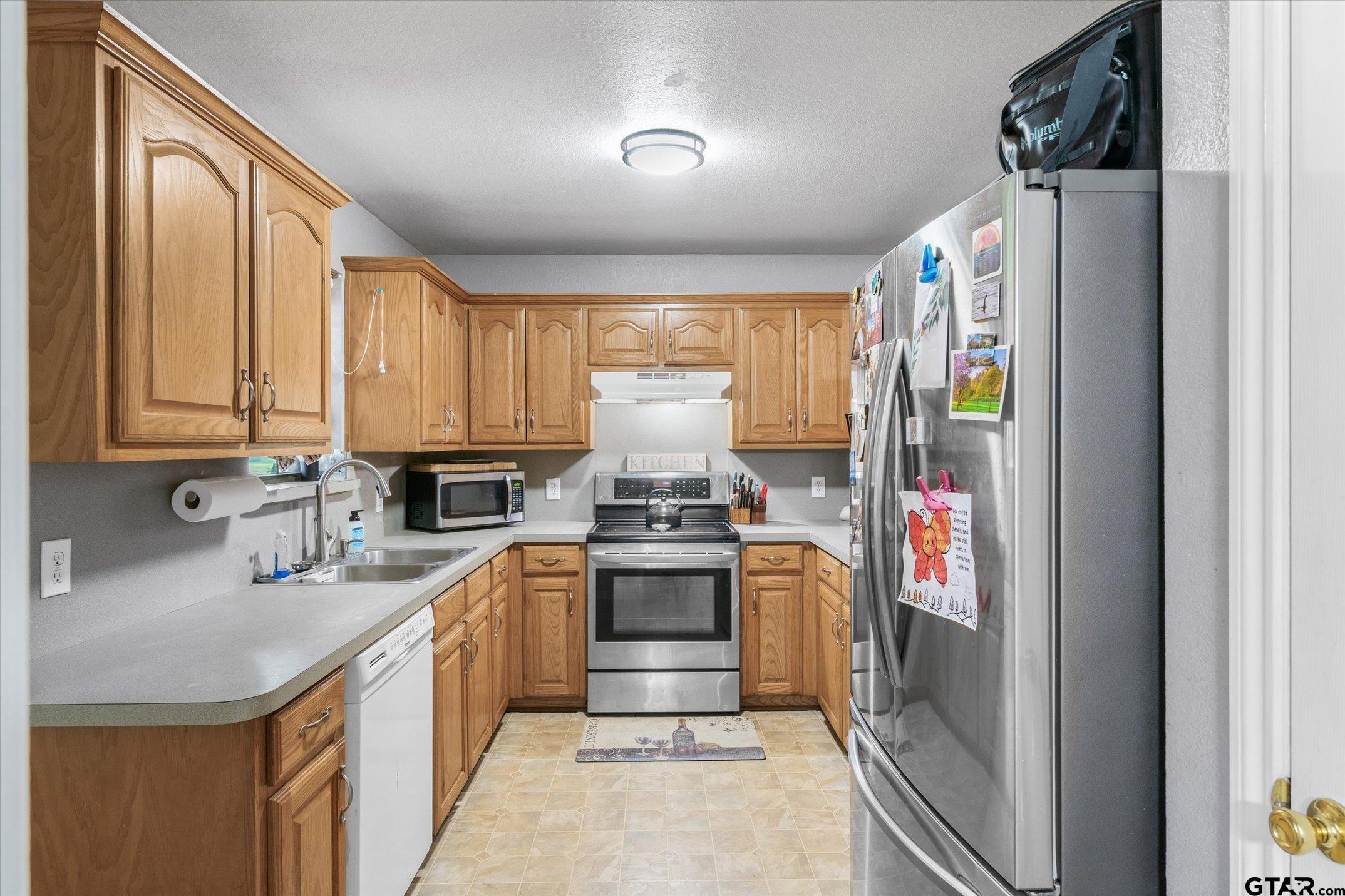 1200 Vz County Road Canton, TX 75103 - Photo 21 of 27 a kitchen with stainless steel appliances granite countertop a sink stove and refrigerator