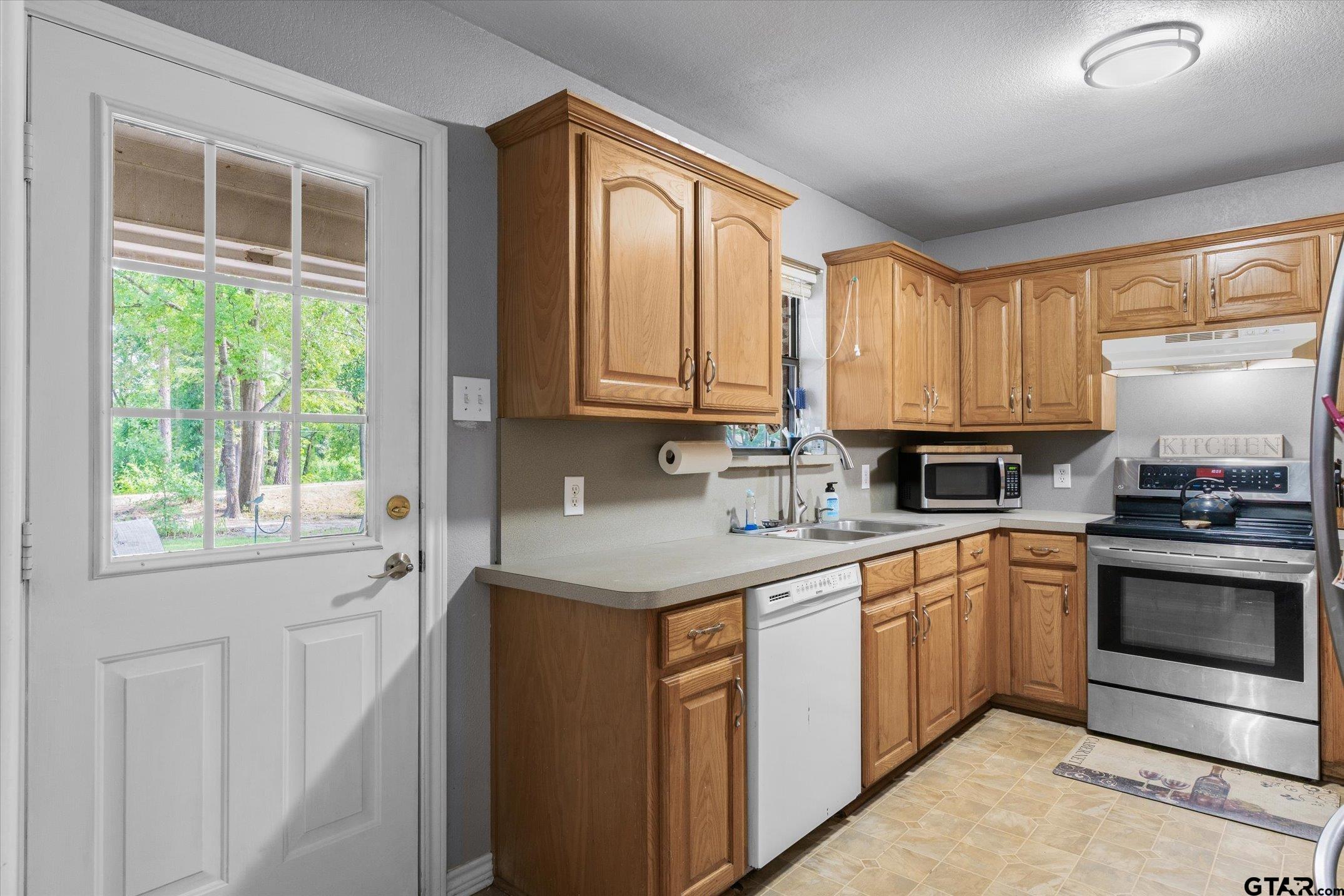 1200 Vz County Road Canton, TX 75103 - Photo 22 of 27 a kitchen with stainless steel appliances granite countertop a stove a sink and a microwave
