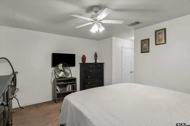 a bedroom with a bed and a dresser