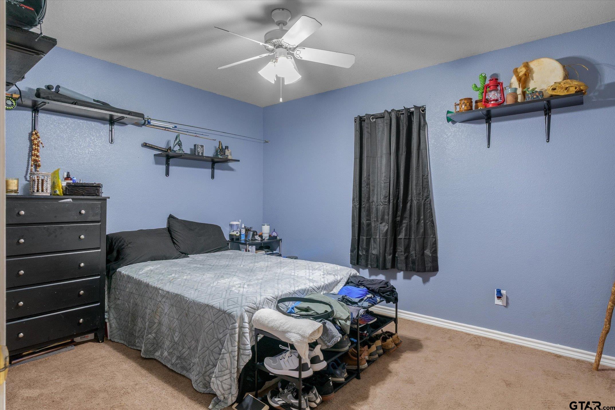 1200 Vz County Road Canton, TX 75103 - Photo 25 of 27 a bedroom with a bed and a chandelier