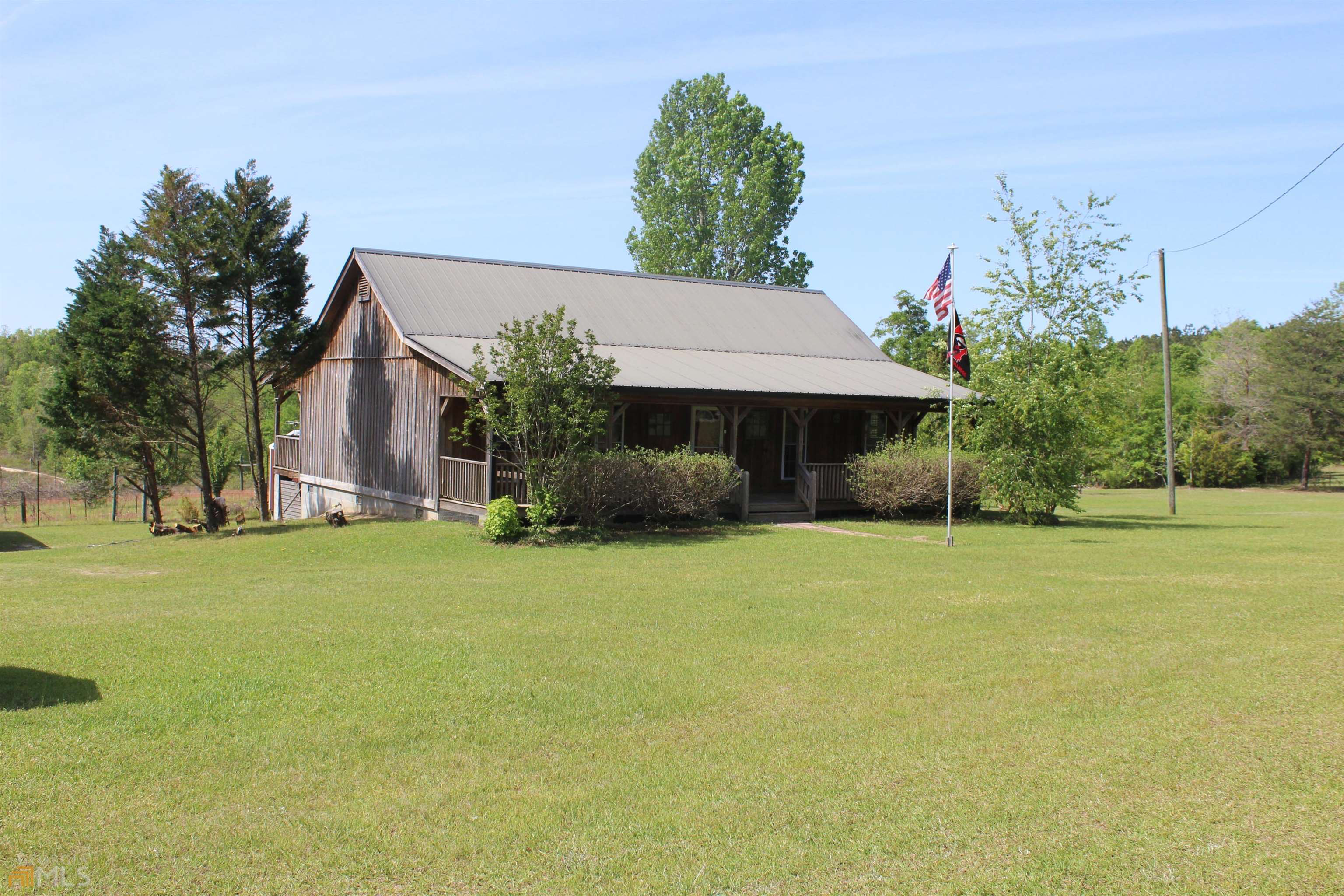 500 Wainwright Road Butler, GA 31006 - Photo 1 of 1 front view of a house with a yard and a garage