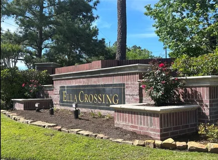 a view of sign board with flower plants