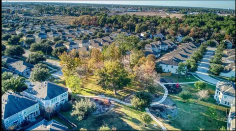 an aerial view of residential houses with outdoor space