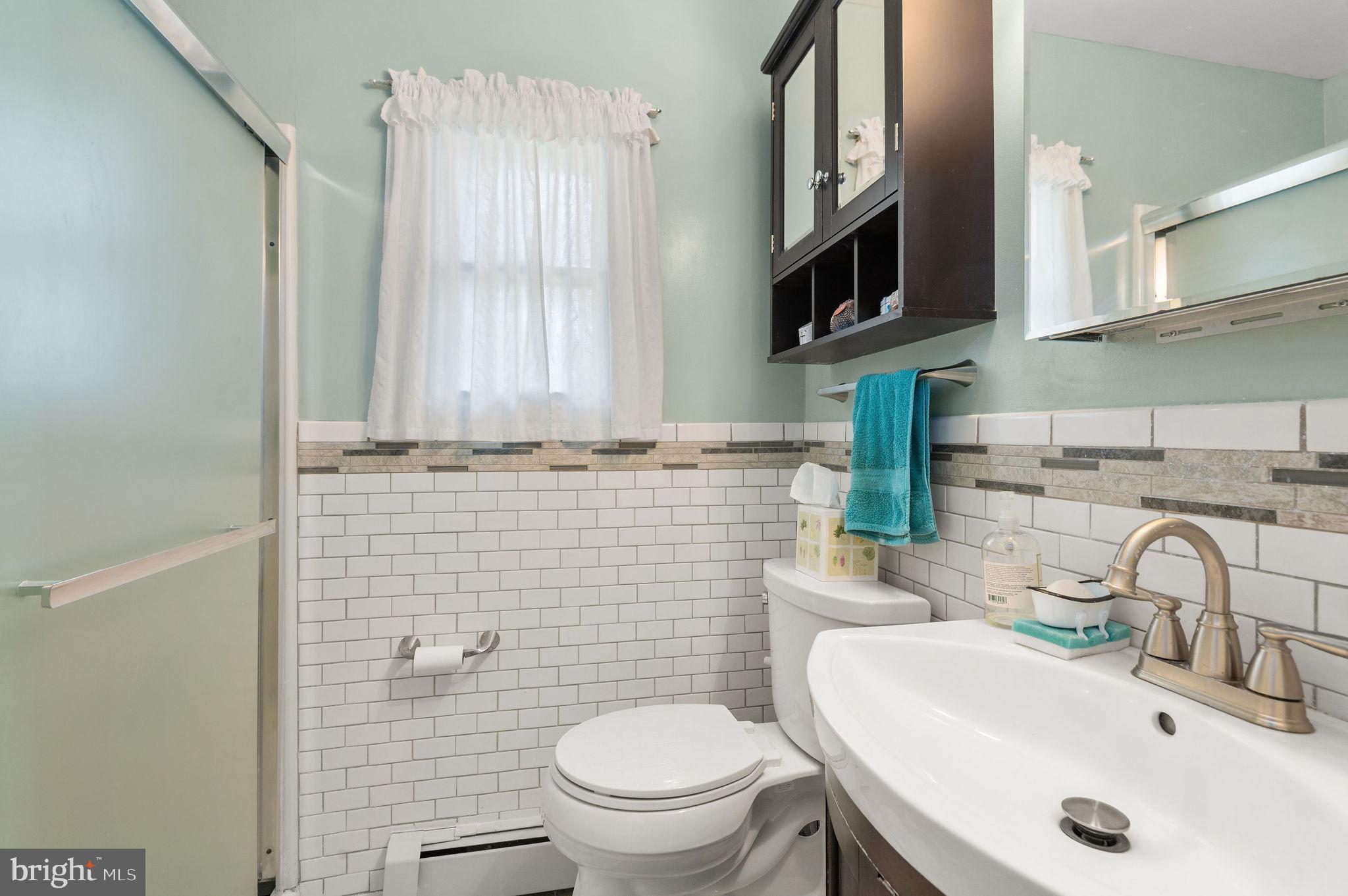 1027 Rozel Avenue Southampton, PA 18966 - Photo 10 of 24 a bathroom with a sink a toilet and a mirror