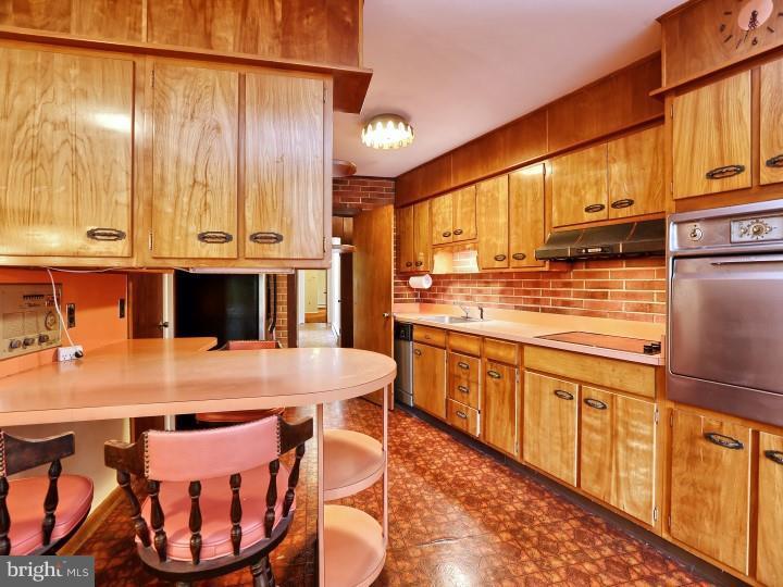 41 Robin Road Moorestown, NJ 08057 - Photo 9 of 23 a kitchen with stainless steel appliances granite countertop a stove a sink and a refrigerator