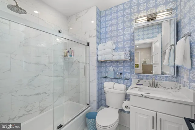 a bathroom with a sink toilet and shower