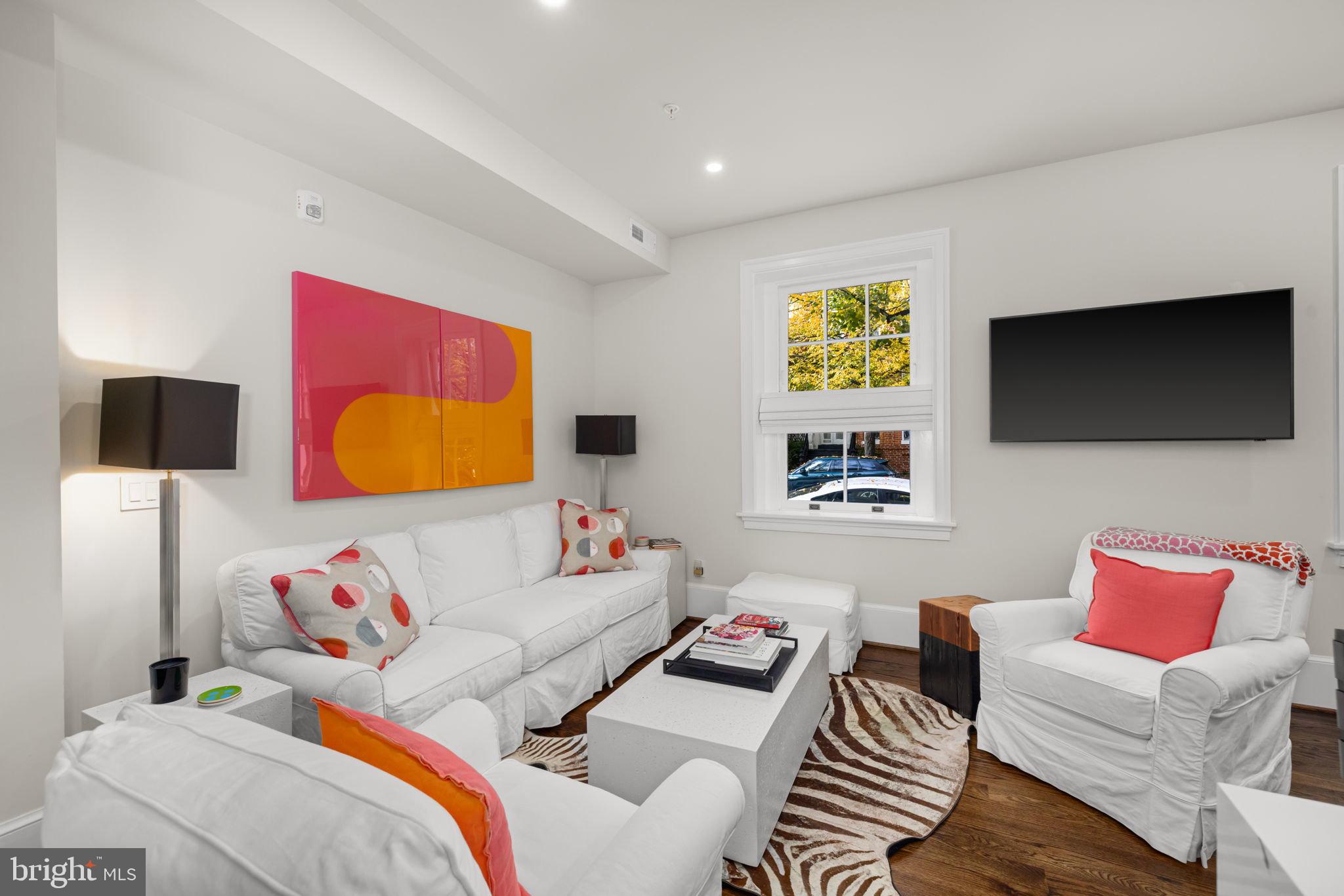 1305 30th Street Northwest, Unit 106 Washington, DC 20007 - Photo 2 of 14 a living room with furniture and a flat screen tv