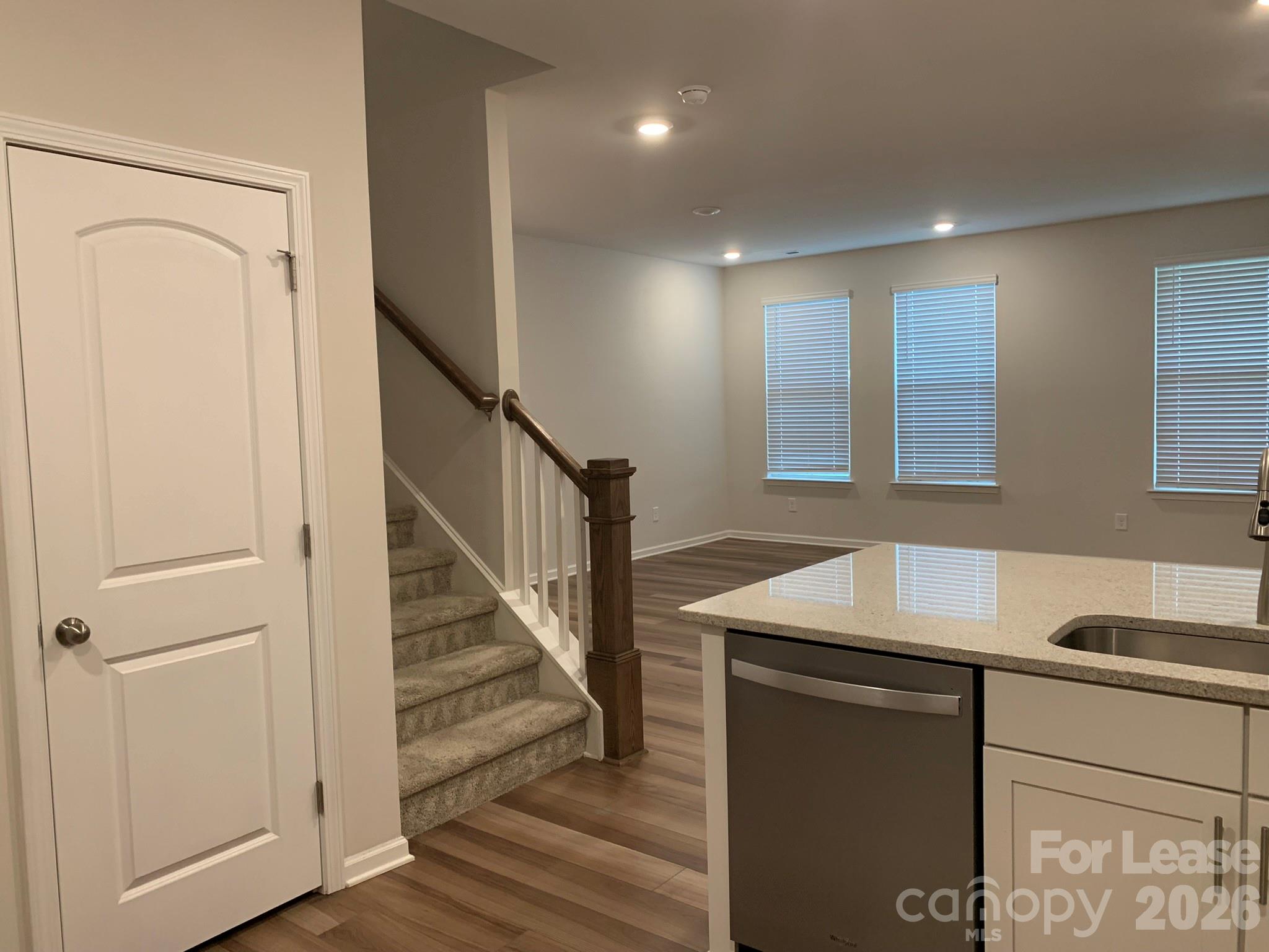 2143 Stevens Mill Road Matthews, NC 28104 - Photo 7 of 39 a kitchen with a sink a refrigerator and cabinets