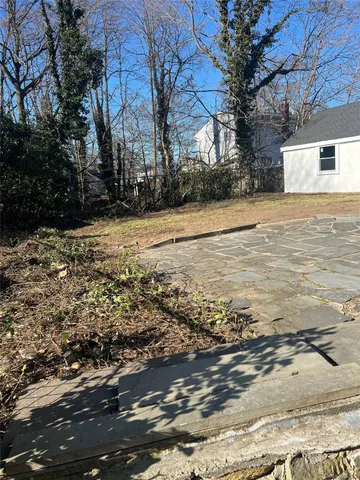 a view of a yard with snow on the road