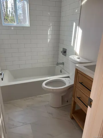 a bathroom with a sink a toilet and bathtub