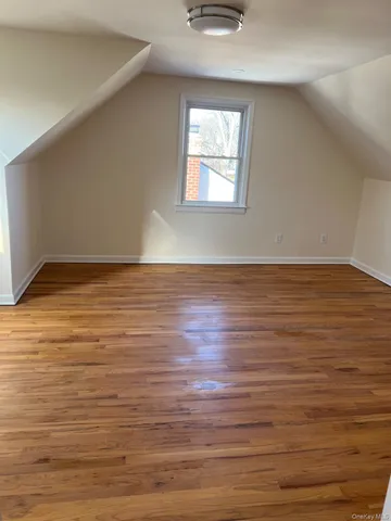 a view of wooden floor and windows in a room