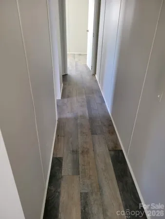 a view of a room with wooden floor and bathroom