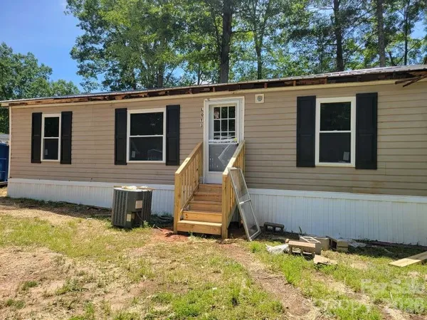 a view of a house with pool and sitting area