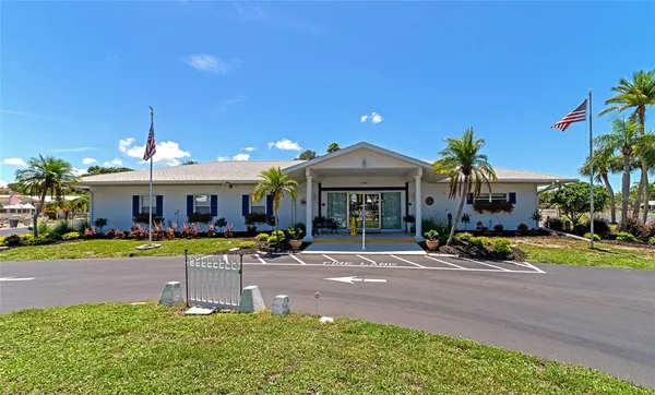 a view of a patio with a table chairs and a yard