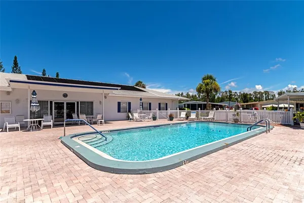 a view of a house with a yard patio and sitting area