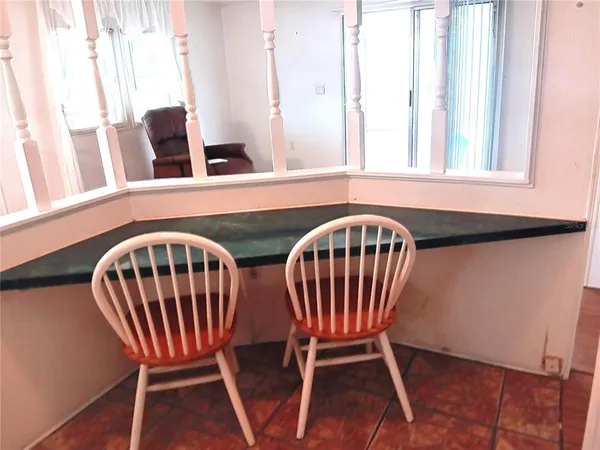 a living room with furniture floor to ceiling window and floor to ceiling window