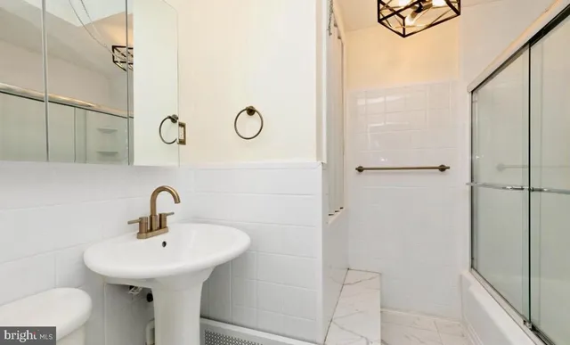 a bathroom with a sink and shower