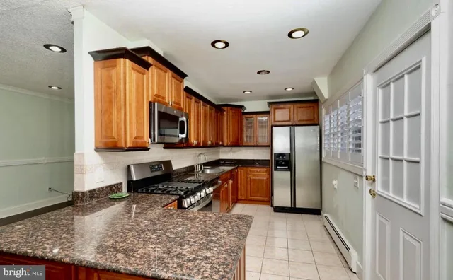 a kitchen with refrigerator and cabinets
