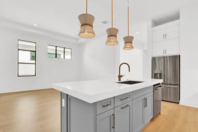 a kitchen with a sink and a refrigerator