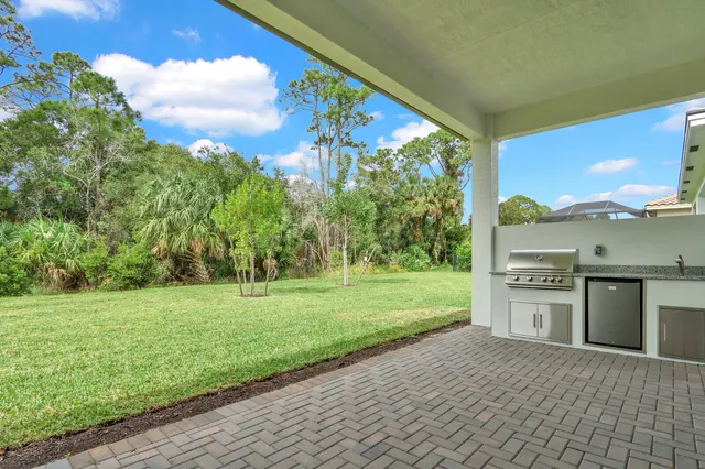 a view of a backyard with a garden and entertaining space