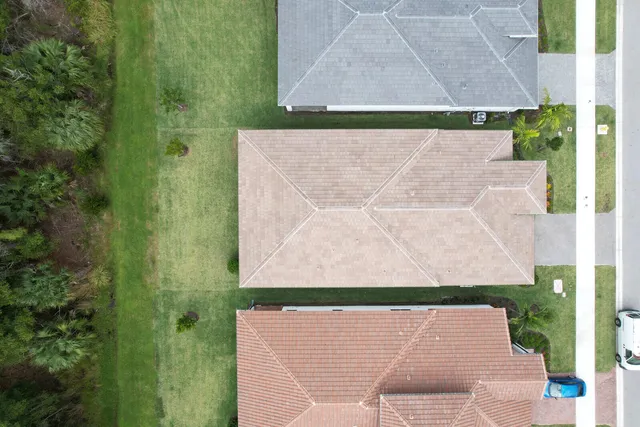 an aerial view of a house with a yard