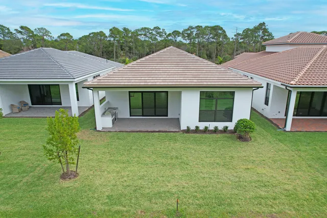 a aerial view of a house with pool and a yard