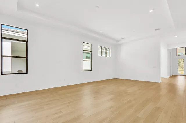 an empty room with windows and closet