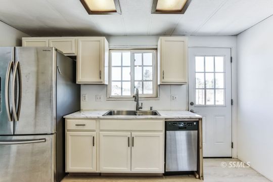4511 Stark Street Ridgecrest, CA 93555 - Photo 11 of 30 a kitchen with stainless steel appliances a sink stove and refrigerator