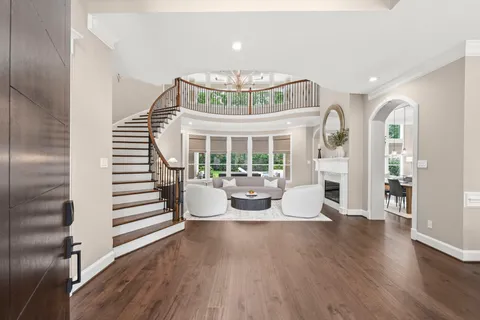 a view of a dining room with furniture a chandelier and wooden floor