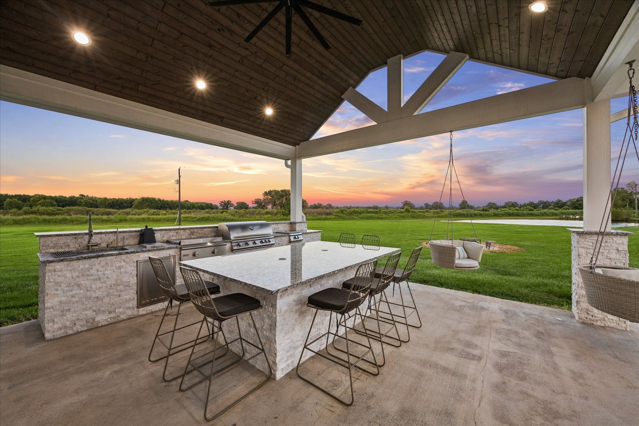 2702 Horseshoe Lane Rosharon, TX 77583 - Photo 11 of 43 Covered outdoor kitchen area with wood-planked ceiling overlooks the beautifully maintained acreage.