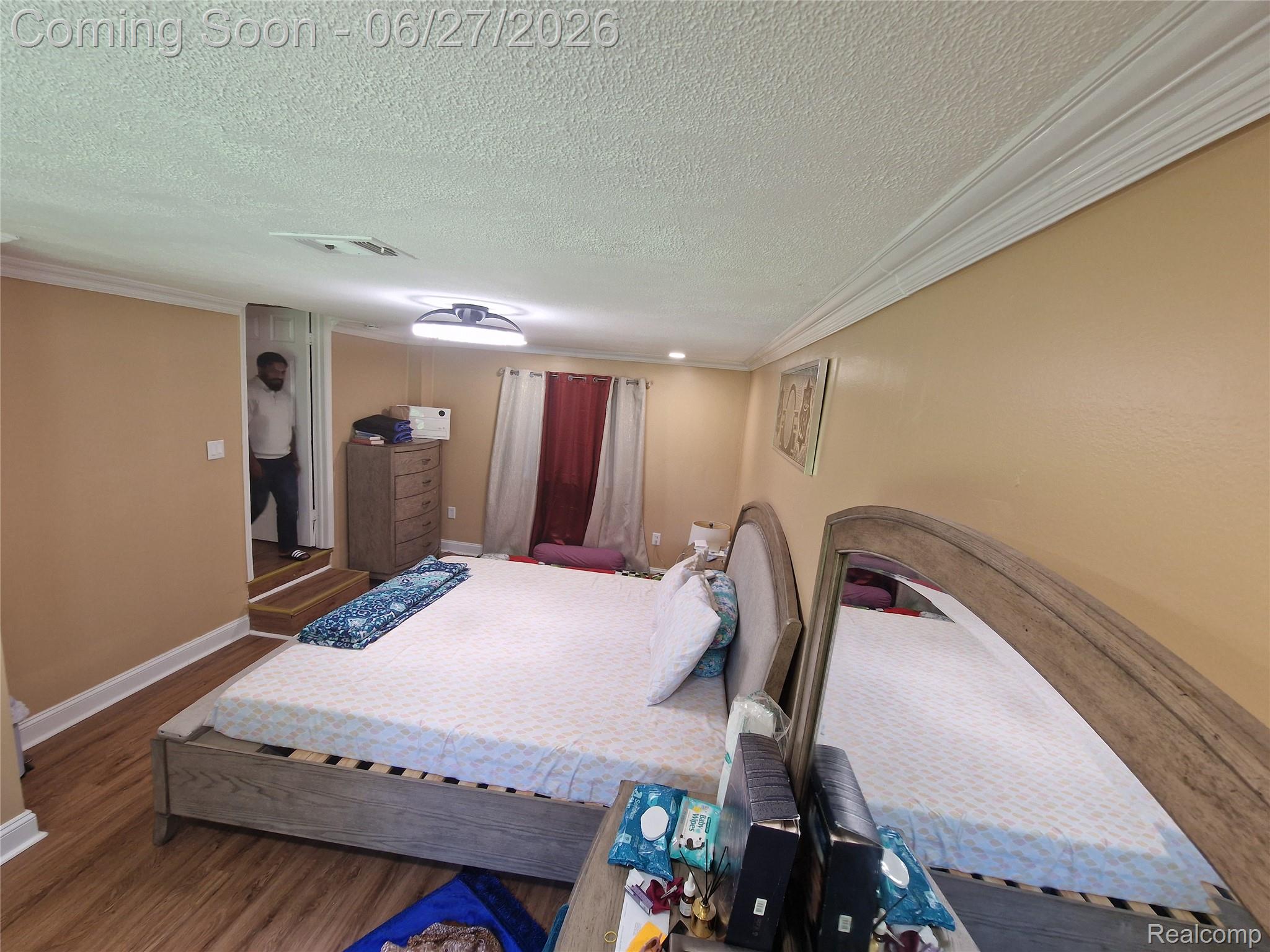 4320 Frazho Road Warren, MI 48091 - Photo 26 of 27 Spacious room featuring wood-finish flooring, light peach walls, white crown molding, and recessed lighting
