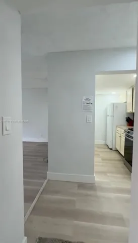 a view of a kitchen from the hallway