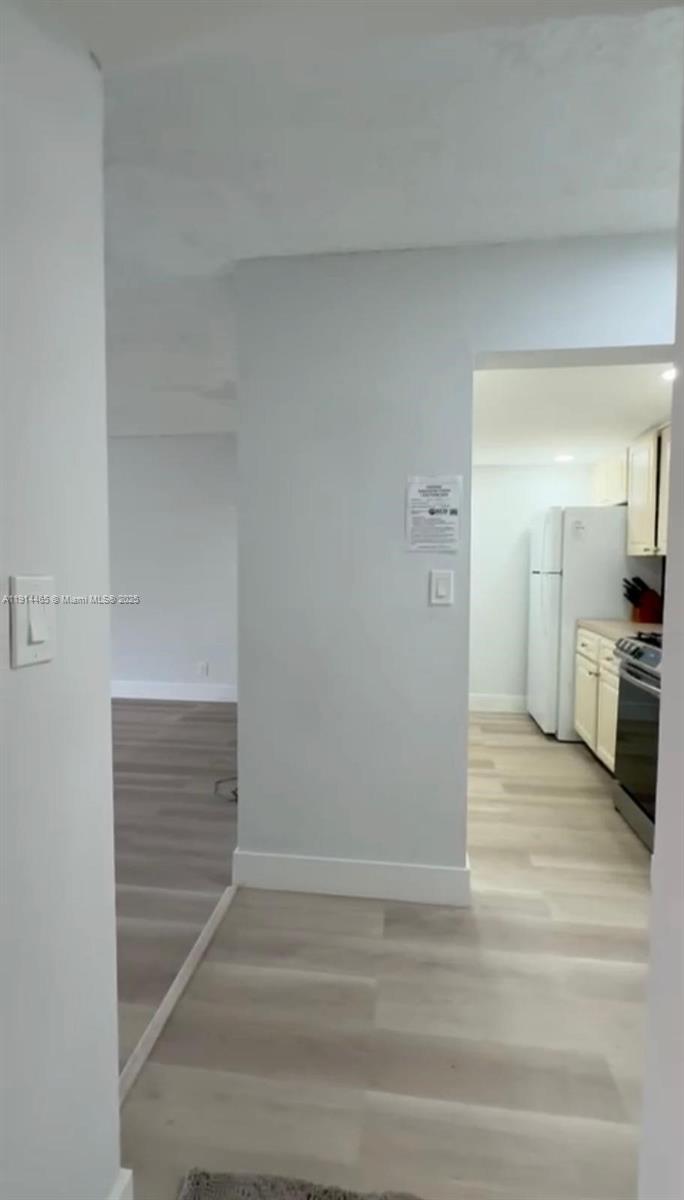 17901 Northwest 68th Avenue, Unit T205 Hialeah, FL 33015 - Photo 1 of 13 a view of a kitchen from the hallway