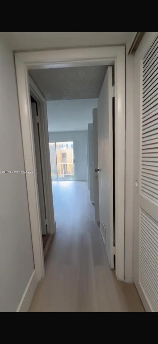 17901 Northwest 68th Avenue, Unit T205 Hialeah, FL 33015 - Photo 13 of 13 a view of a hallway and wooden floor