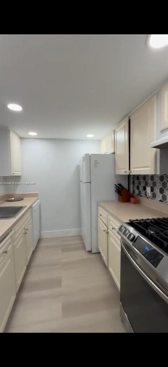 17901 Northwest 68th Avenue, Unit T205 Hialeah, FL 33015 - Photo 2 of 13 a kitchen with granite countertop a sink stove and refrigerator