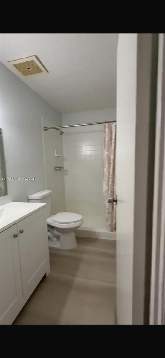17901 Northwest 68th Avenue, Unit T205 Hialeah, FL 33015 - Photo 6 of 13 a bathroom with a sink a toilet and shower