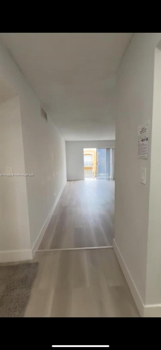 17901 Northwest 68th Avenue, Unit T205 Hialeah, FL 33015 - Photo 9 of 13 a view of an empty room and window