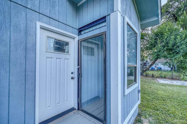 a view of a yard with a house and large tree