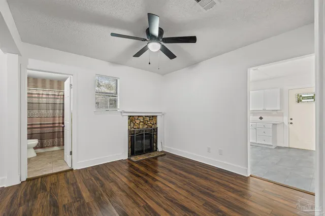 wooden floor in an empty room with a fireplace